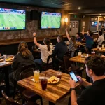Intensely focused sports betting scene with fans analyzing nhandinhkeonhacai odds on smartphones