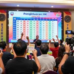 Excited participants at a lottery event for Pengeluaran HK results, celebrating live draws and cheering.