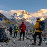 Trekkers at Everest Base Camp enjoying breathtaking views of Mount Everest during sunset.
