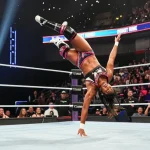 Roxanne Perez performing an impressive move in a wrestling match, showcasing her athleticism and skills.